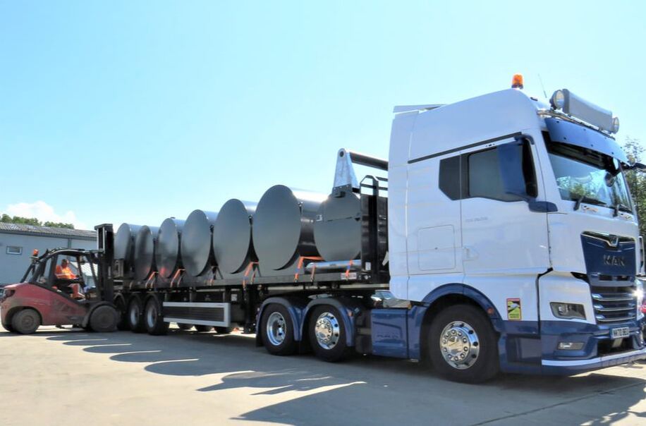 A white HGV is loaded up with Fuel Proof fuel tanks by a forklift truck